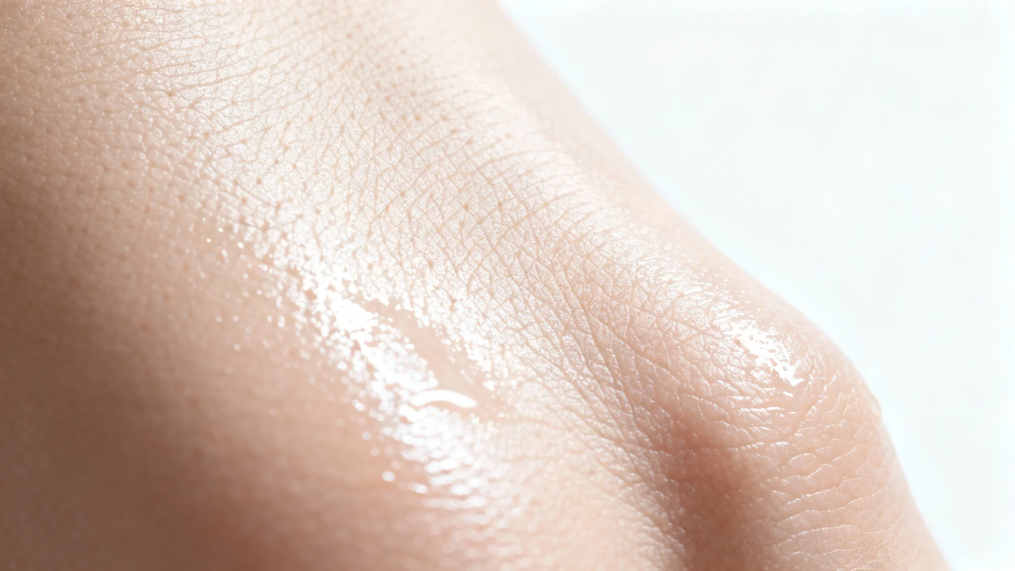 A hyper-realistic macro shot of healthy, smooth human skin texture, showing fine pores and a dewy glow against a clean white background.