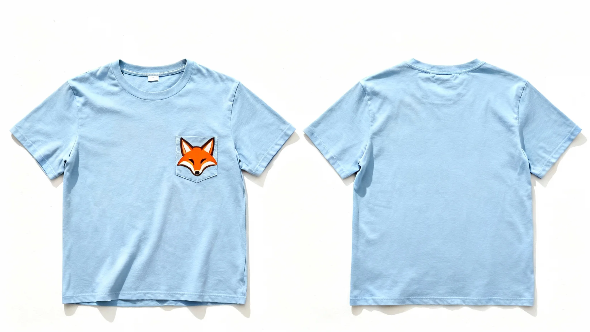 A professional product mockup showing a light blue pocket t-shirt flat-lay. A new, custom-designed orange fox logo is perfectly printed on the pocket, demonstrating the final result of the mockup tool.