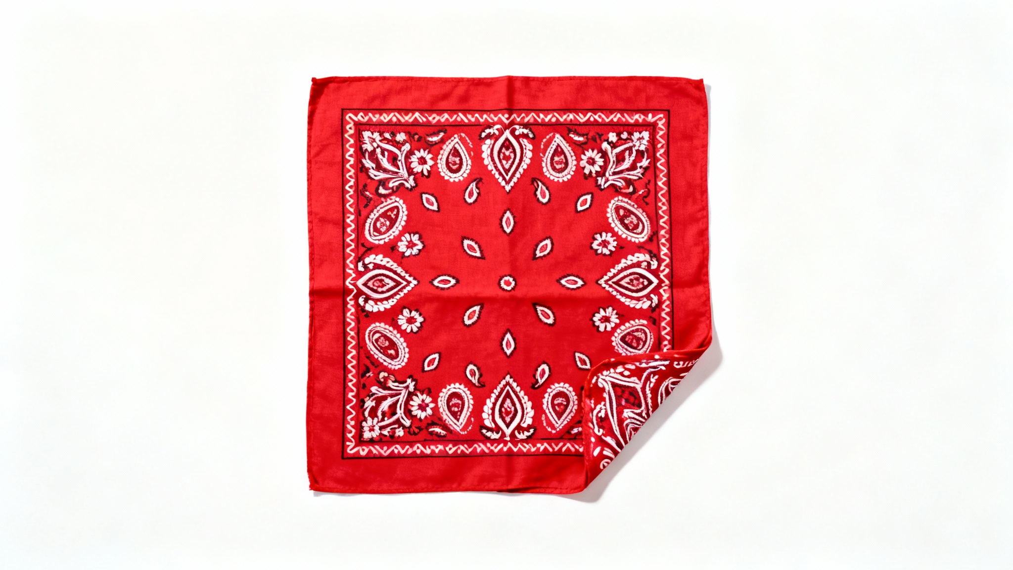 A classic red bandana with an intricate white paisley pattern, displayed flat against a clean white background.