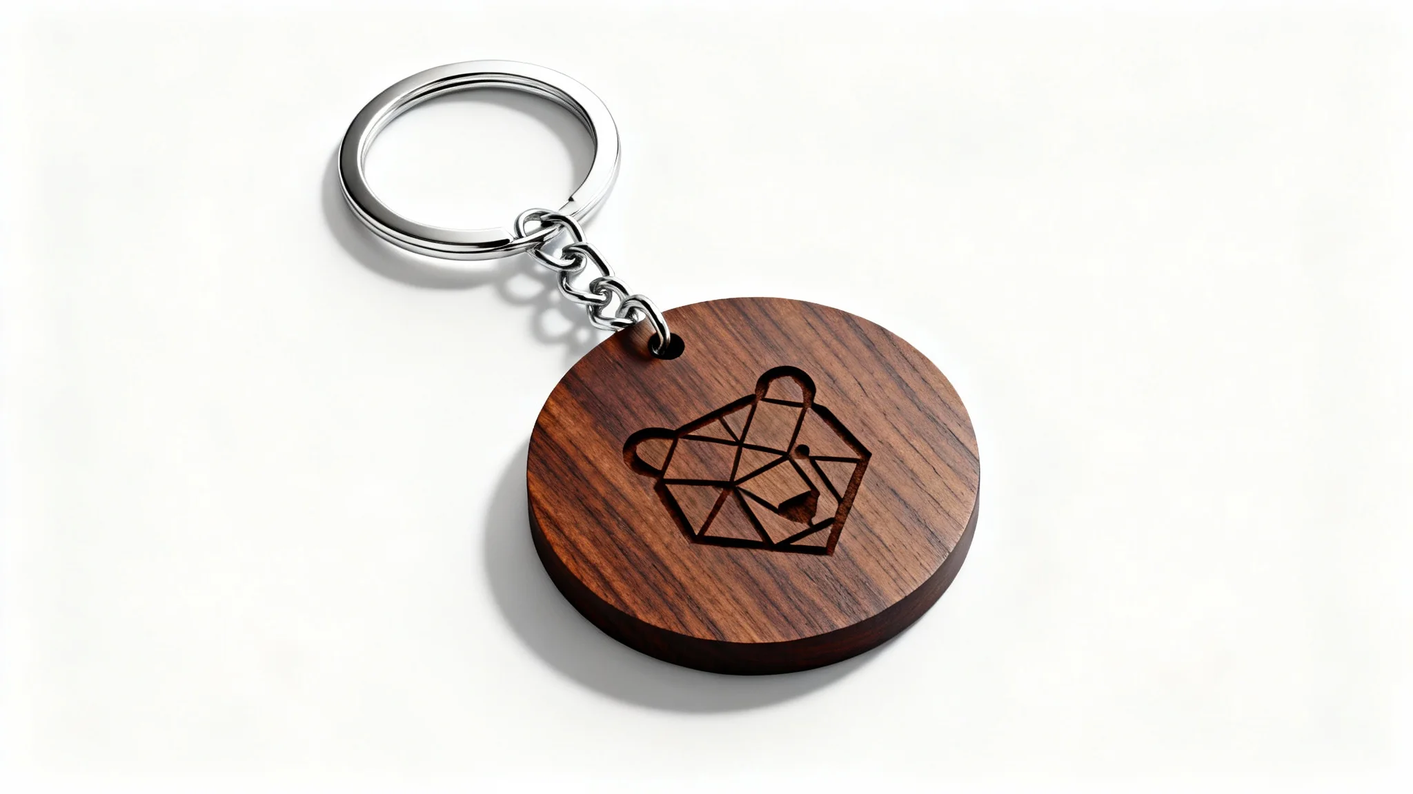 A photorealistic mockup of a circular wooden keychain with a laser-etched geometric bear icon, shown on a clean white background.