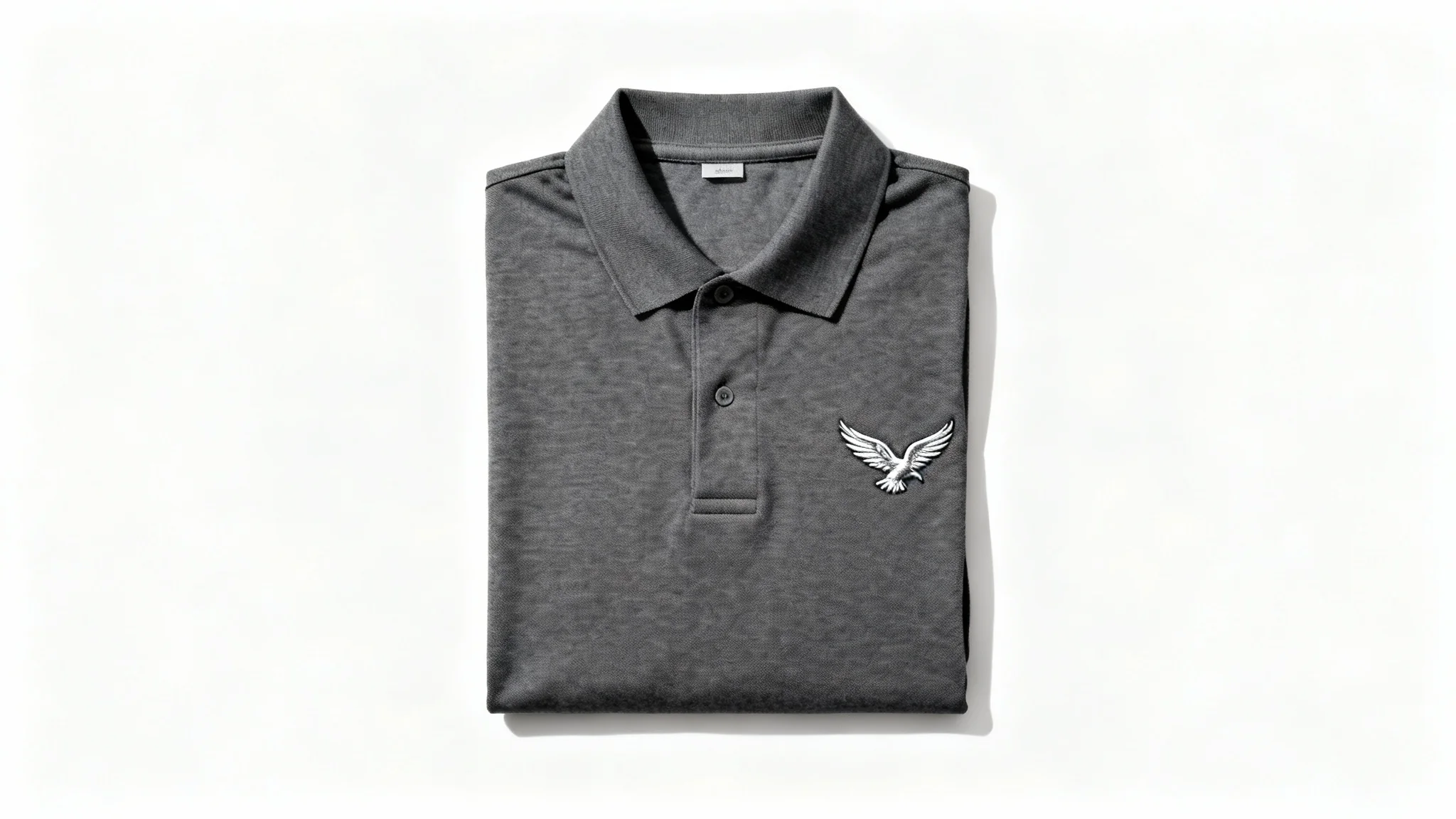 A high-quality product photo of a folded dark gray polo shirt uniform with a silver eagle logo embroidered on the chest, displayed against a clean white background.