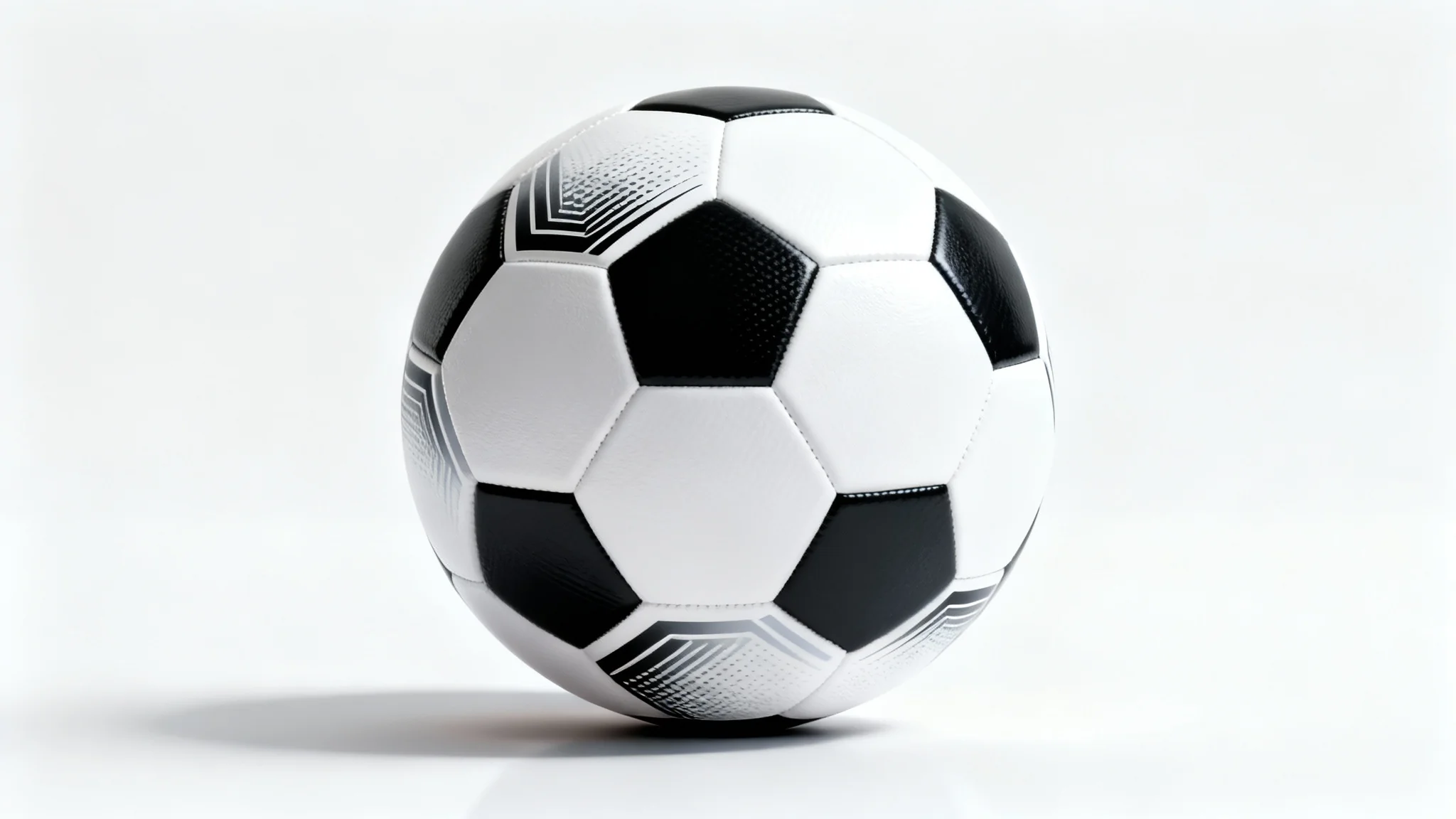 A close-up studio shot of a modern black and white soccer ball resting on a reflective white surface against a plain white background, highlighting its texture and design.