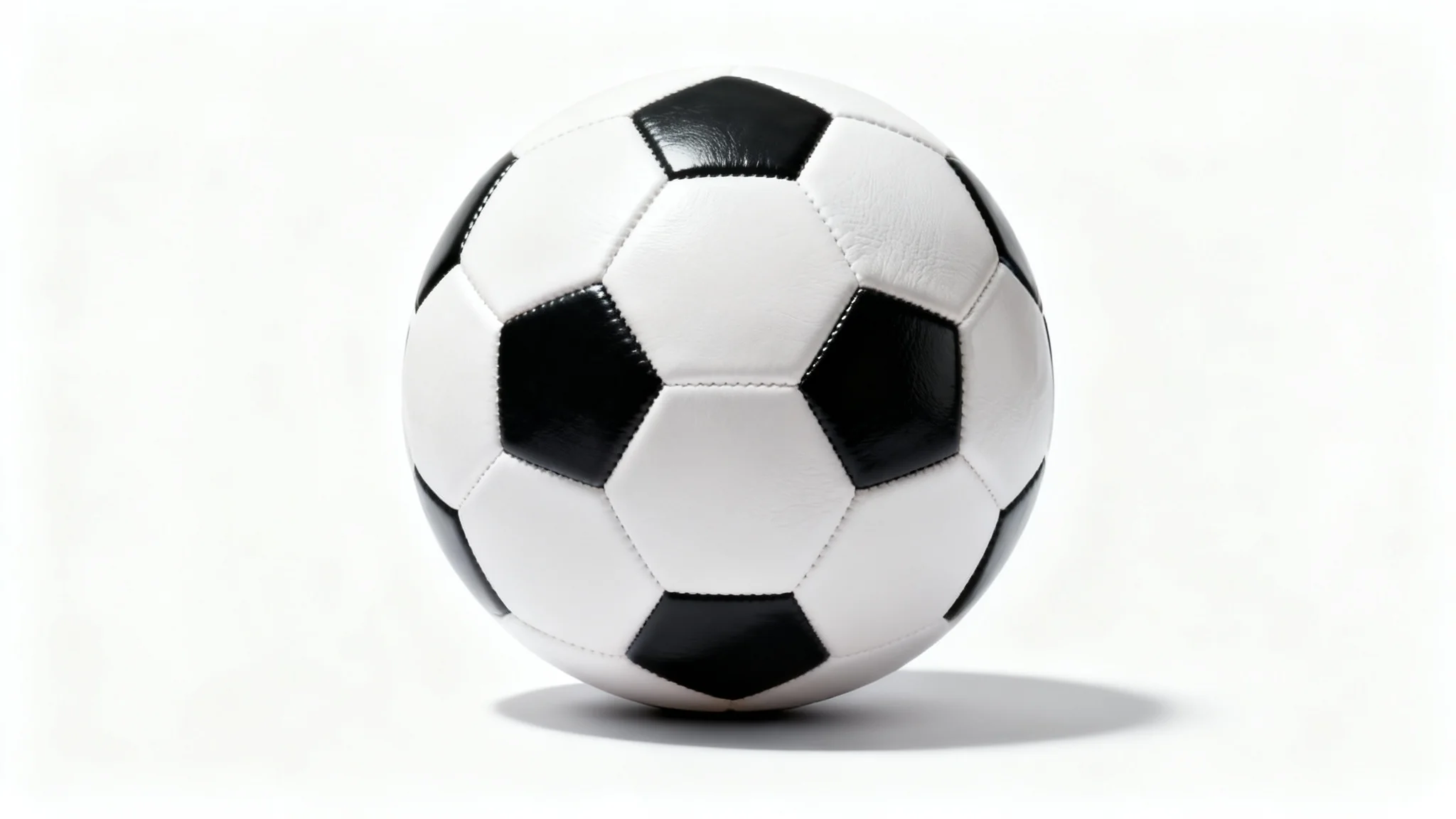A high-resolution product shot of a classic black and white soccer ball positioned in the center against a stark white background.
