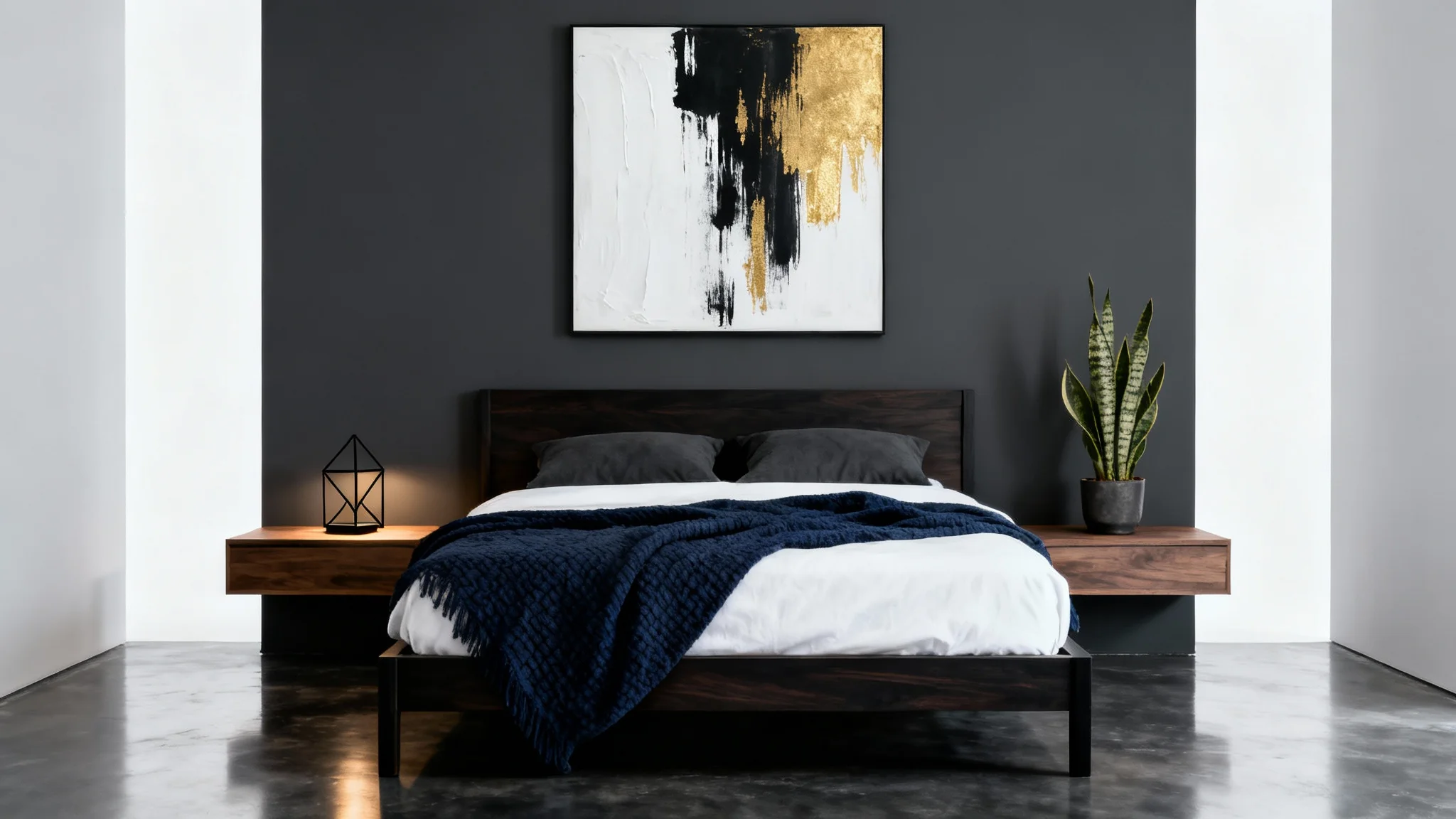 A modern masculine bedroom design featuring a bed with a white duvet and navy throw, set against a dark charcoal accent wall with abstract art, on a white background.