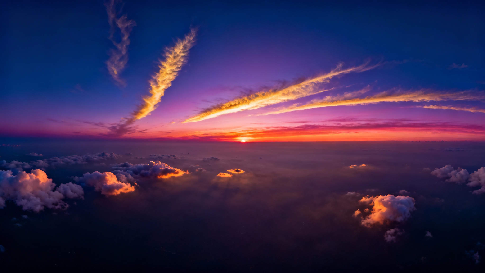 A breathtaking 360-degree panoramic view of a sunset sky, filled with vibrant orange, pink, and purple clouds stretching across a wide horizon, creating an immersive and serene scene.