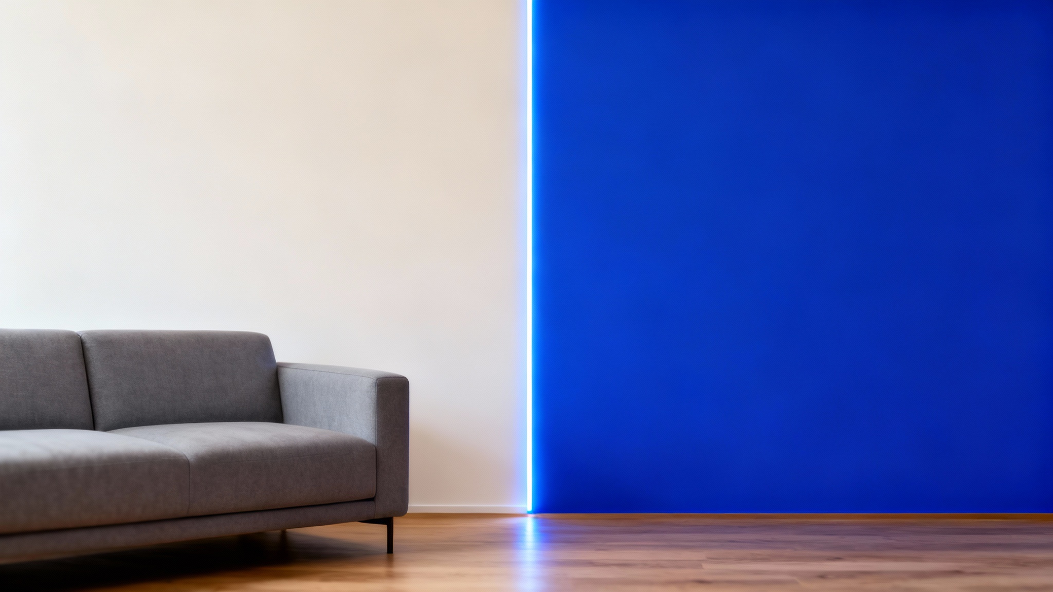 A modern living room wall shown half in a neutral beige color and half being digitally painted a vibrant blue, illustrating a virtual wall painting tool.