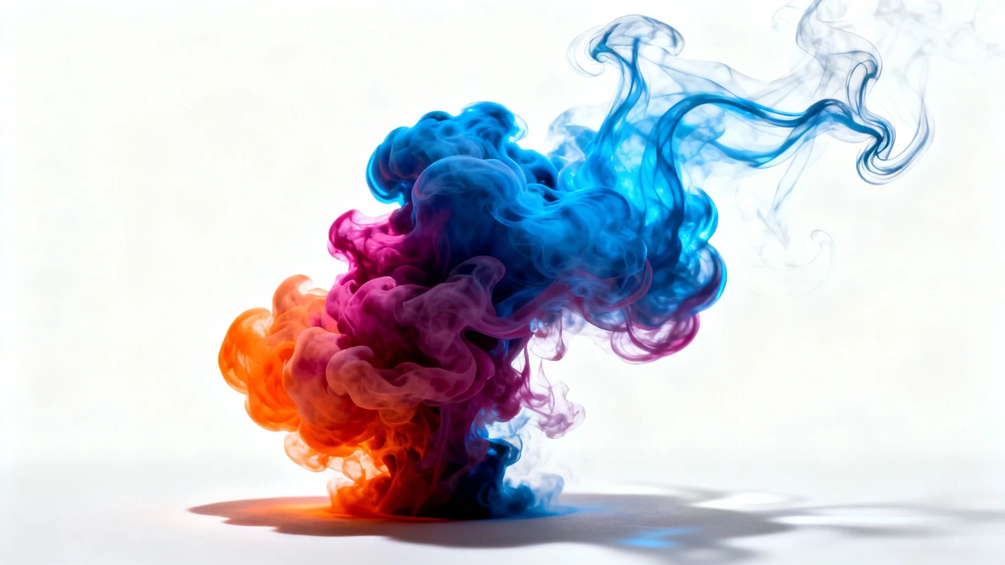 A vibrant plume of multi-colored smoke, in shades of blue, magenta, and orange, swirling elegantly against a stark white background.