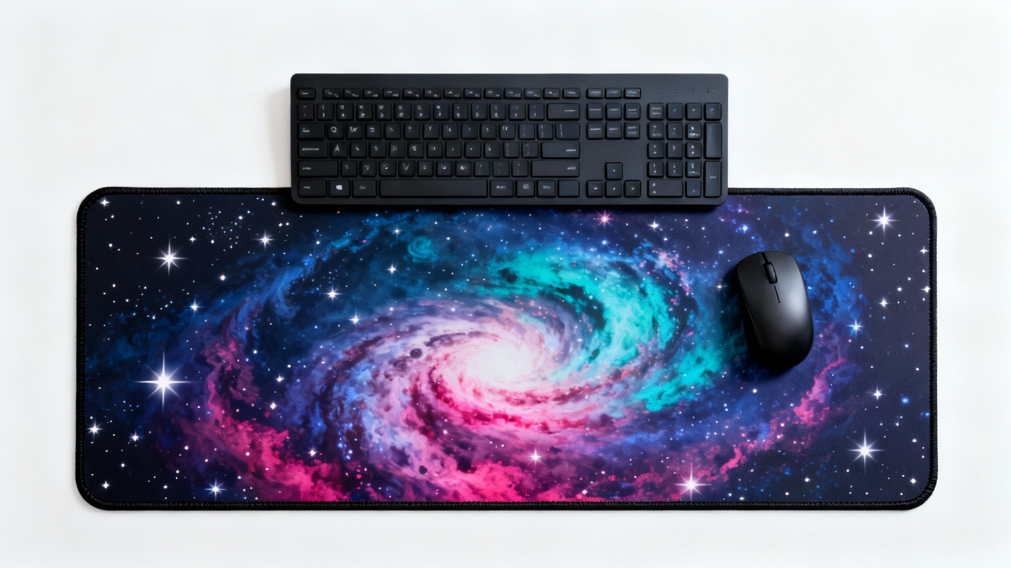 A photorealistic mockup of an extended mousepad with a colorful cosmic nebula design, shown on a clean white surface with a black keyboard and mouse placed on top.