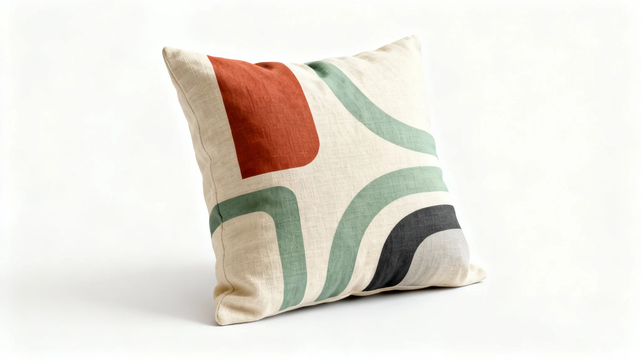 A close-up studio shot of a plush square cushion with a minimalist abstract design in terracotta and sage green, set against a plain white background.