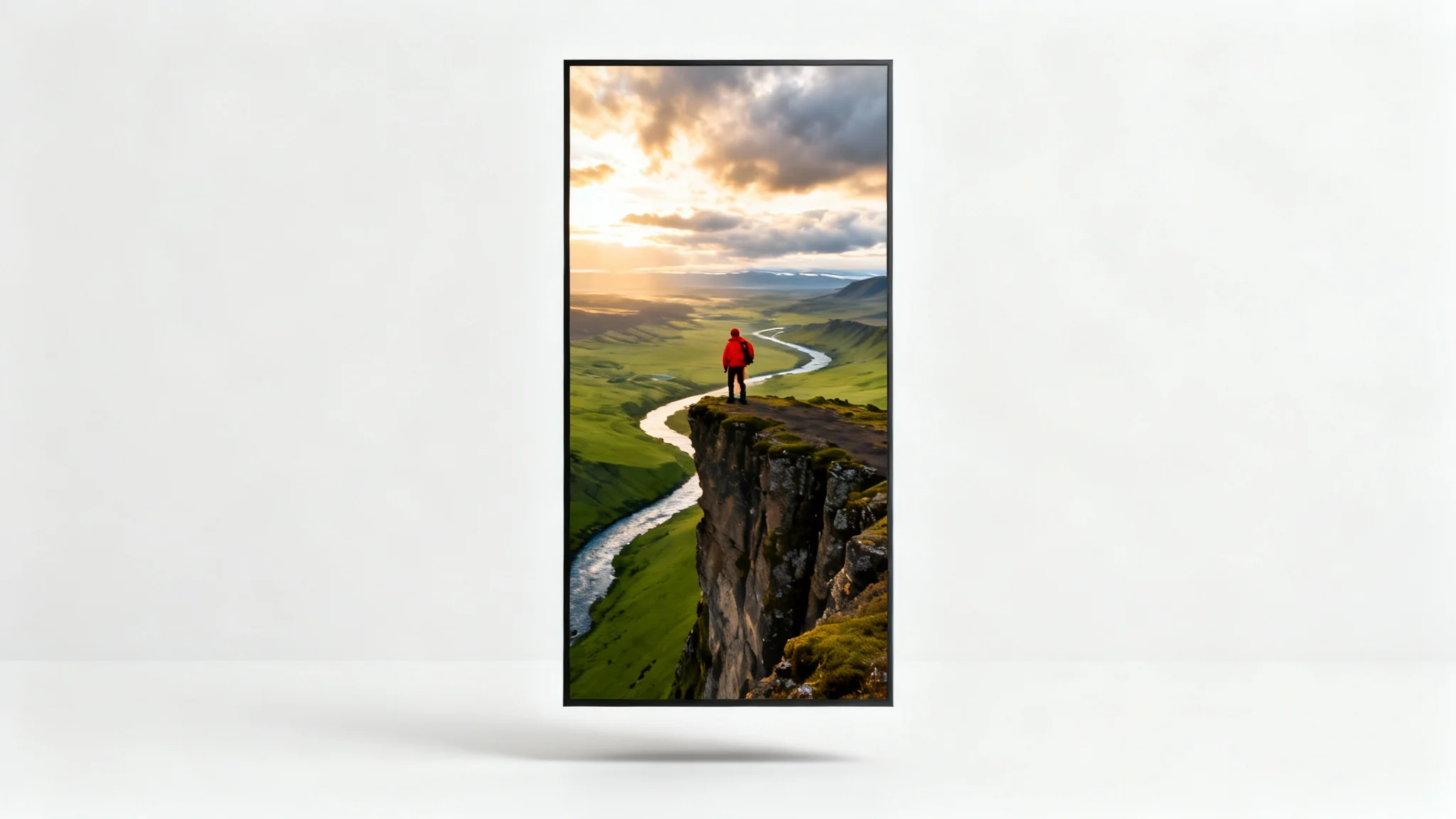 Mockup of a vertical 9:16 video showing an aerial view of a hiker in red on a cliff in Iceland, set against a clean white background.