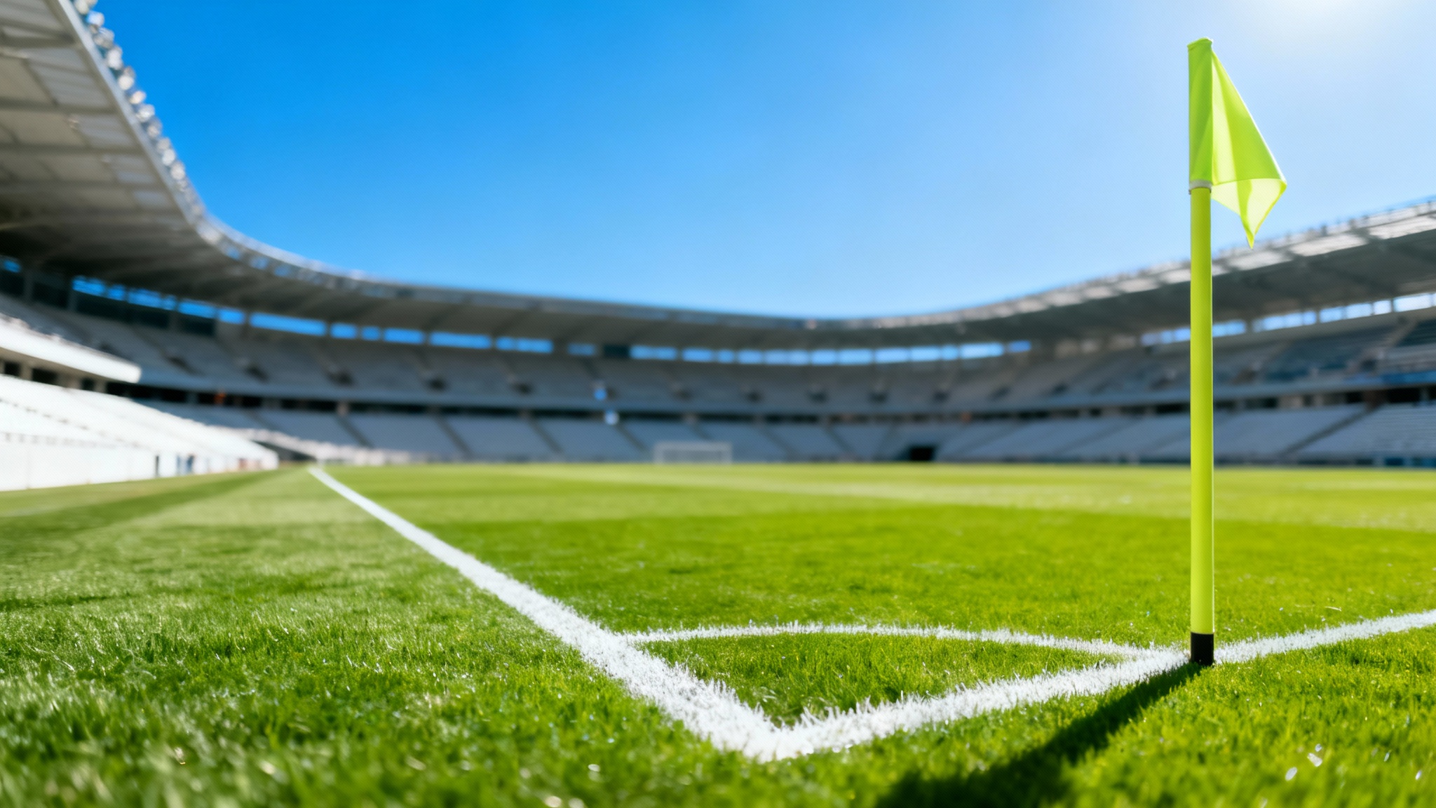 A stunning, wide-angle photograph of an empty professional soccer field on a sunny day, viewed from the corner flag, highlighting the perfect green grass and white lines.