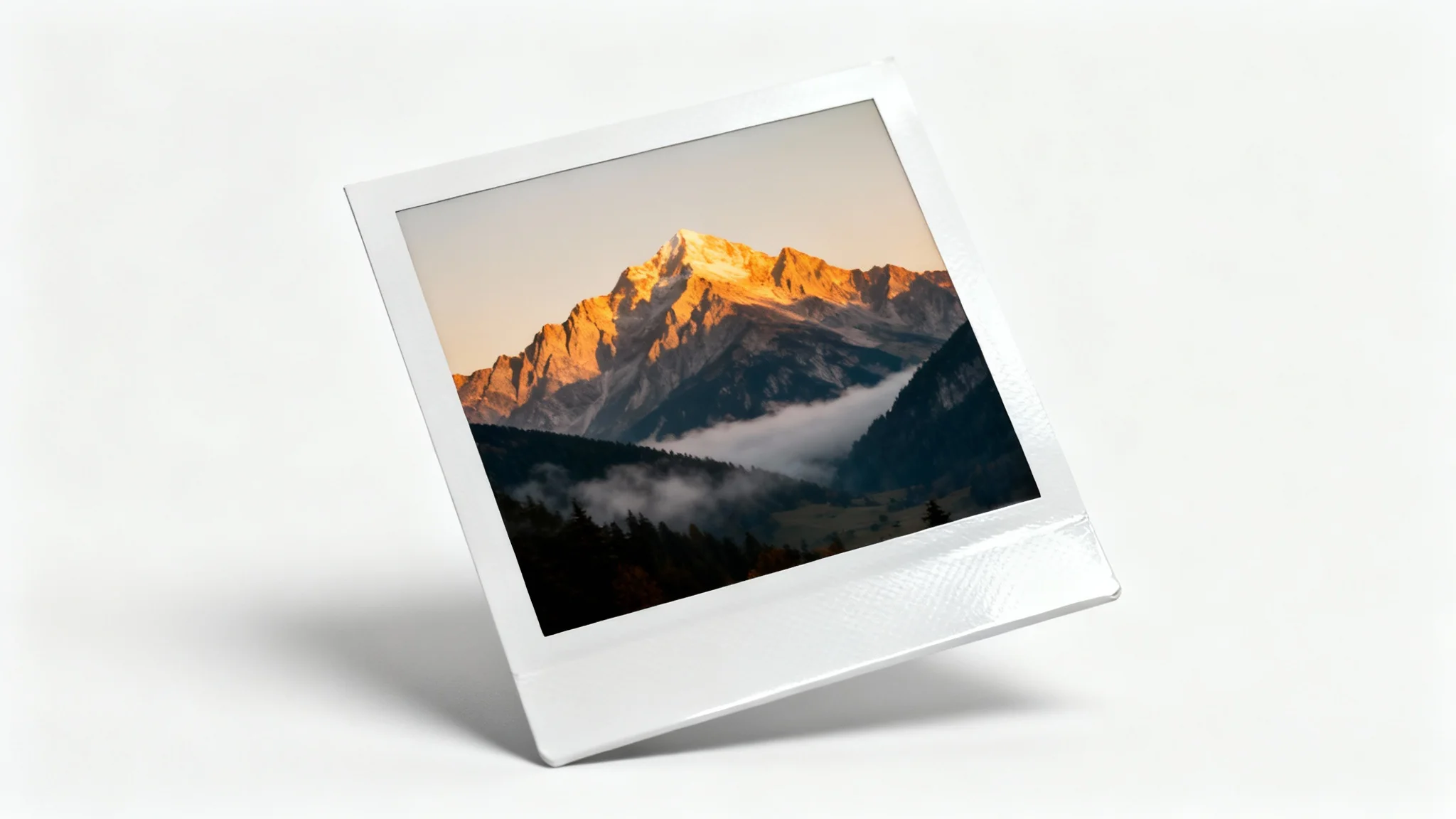 A realistic mockup of a single Polaroid photo displaying a scenic mountain landscape at sunrise, set against a plain white background.