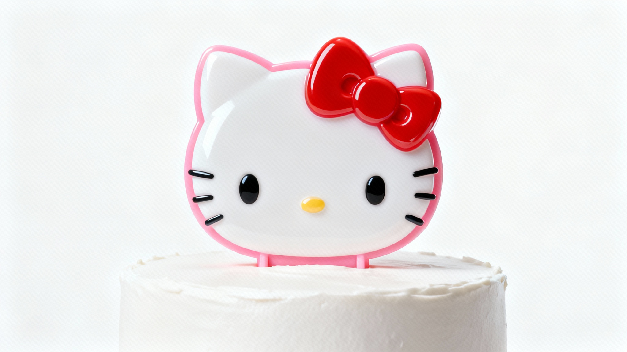A high-quality product mockup of a Hello Kitty cake topper, featuring the character in glossy pink and white, placed on a simple white cake against a plain white background.
