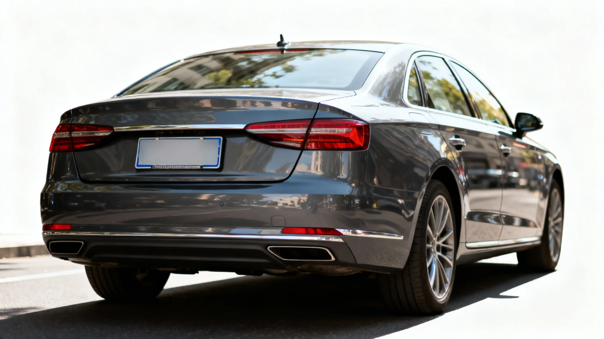 Rear view of a modern dark gray car with its license plate intentionally blurred out to demonstrate a privacy feature, set against a white background.