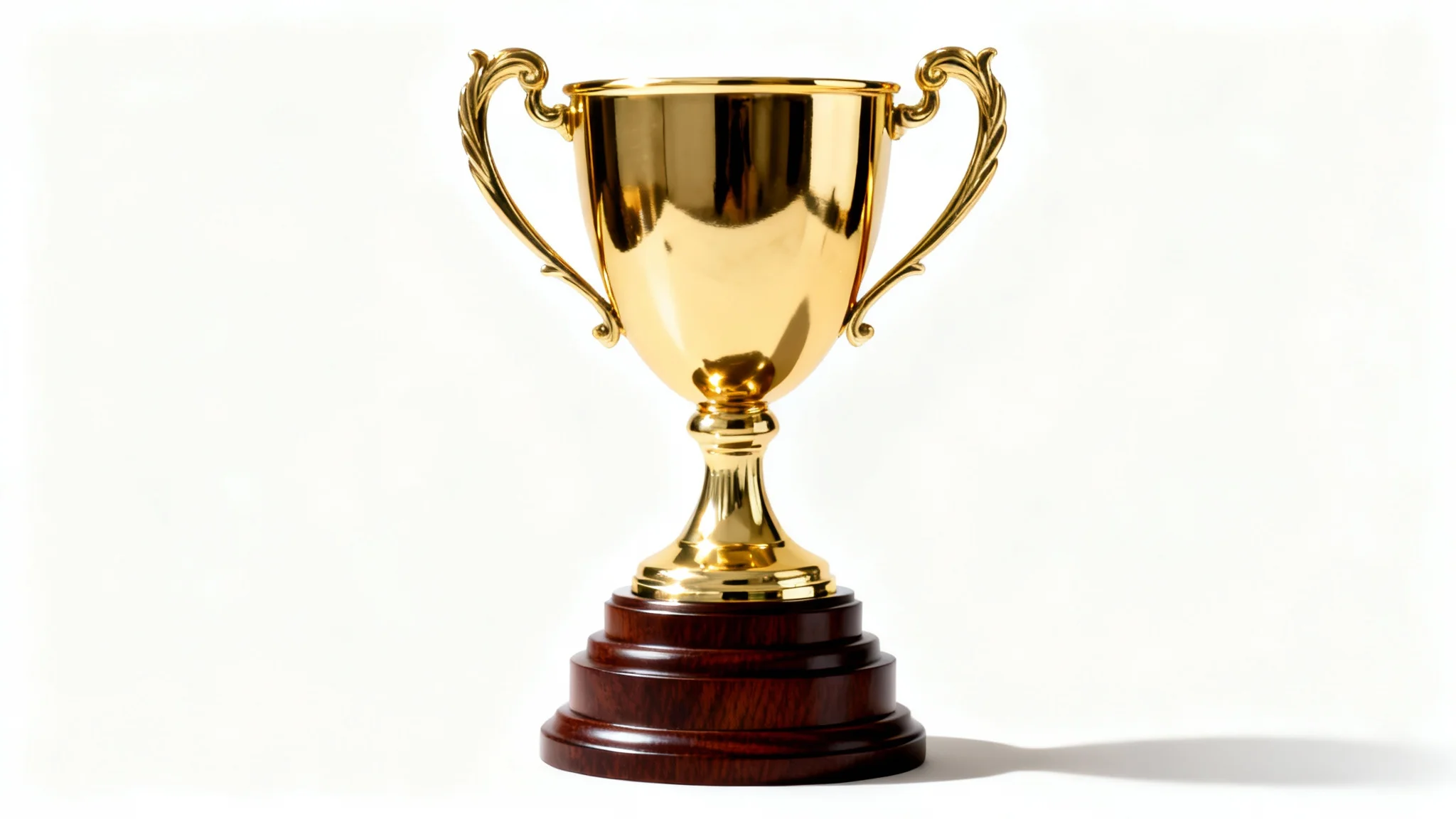 A close-up shot of a shiny gold trophy with elegant handles and a wooden base, isolated against a plain white background.