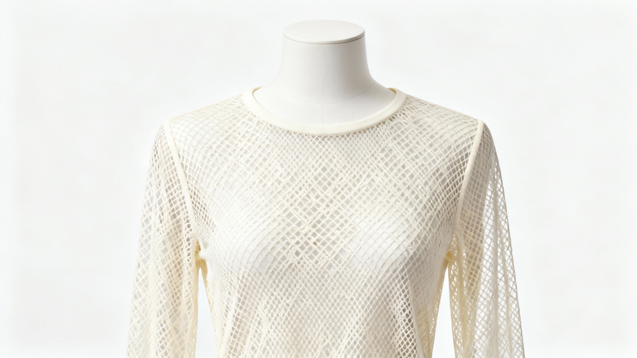 A finely crafted cream-colored long-sleeve mesh top displayed on a white mannequin, showcasing a beautiful sewing pattern result against a white background.