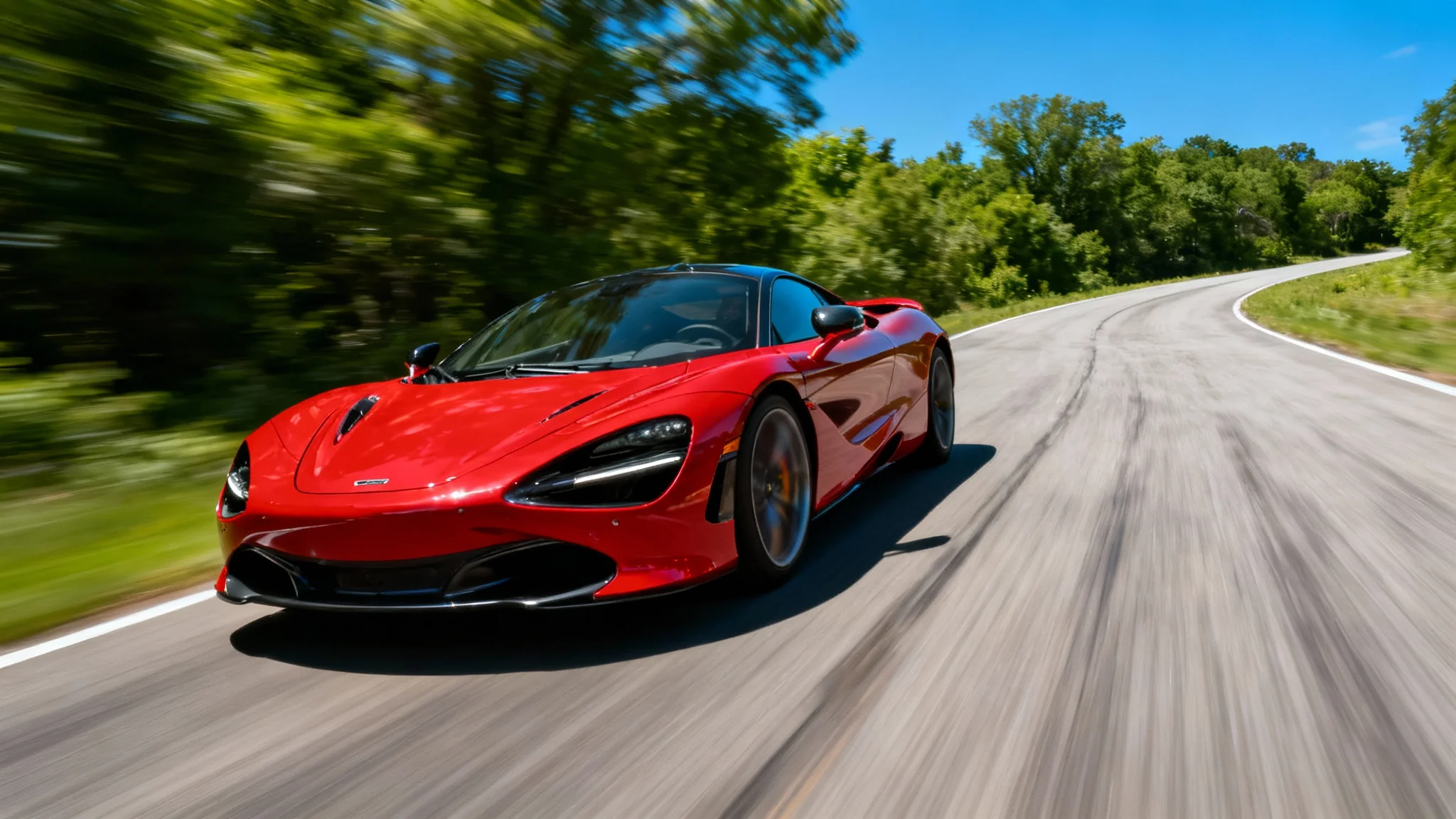A red sports car in sharp focus speeds down a road, with the background blurred to create a dramatic motion effect, demonstrating a photo editing tool's output.