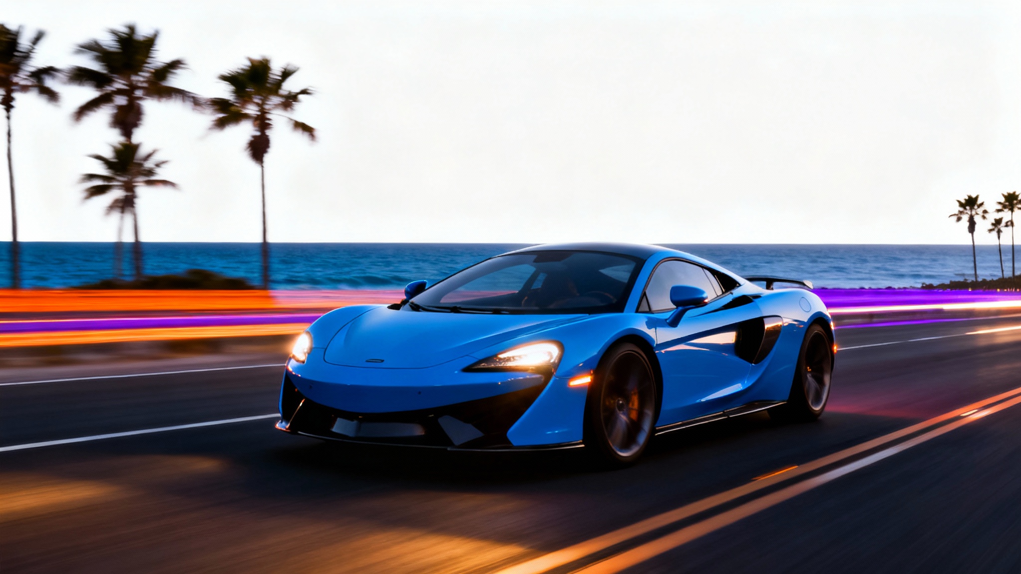 A dynamic image demonstrating motion blur, featuring a sharp, electric blue sports car speeding along a coastal road at twilight, with the background blurred into colorful horizontal streaks. The image is set against a white background.