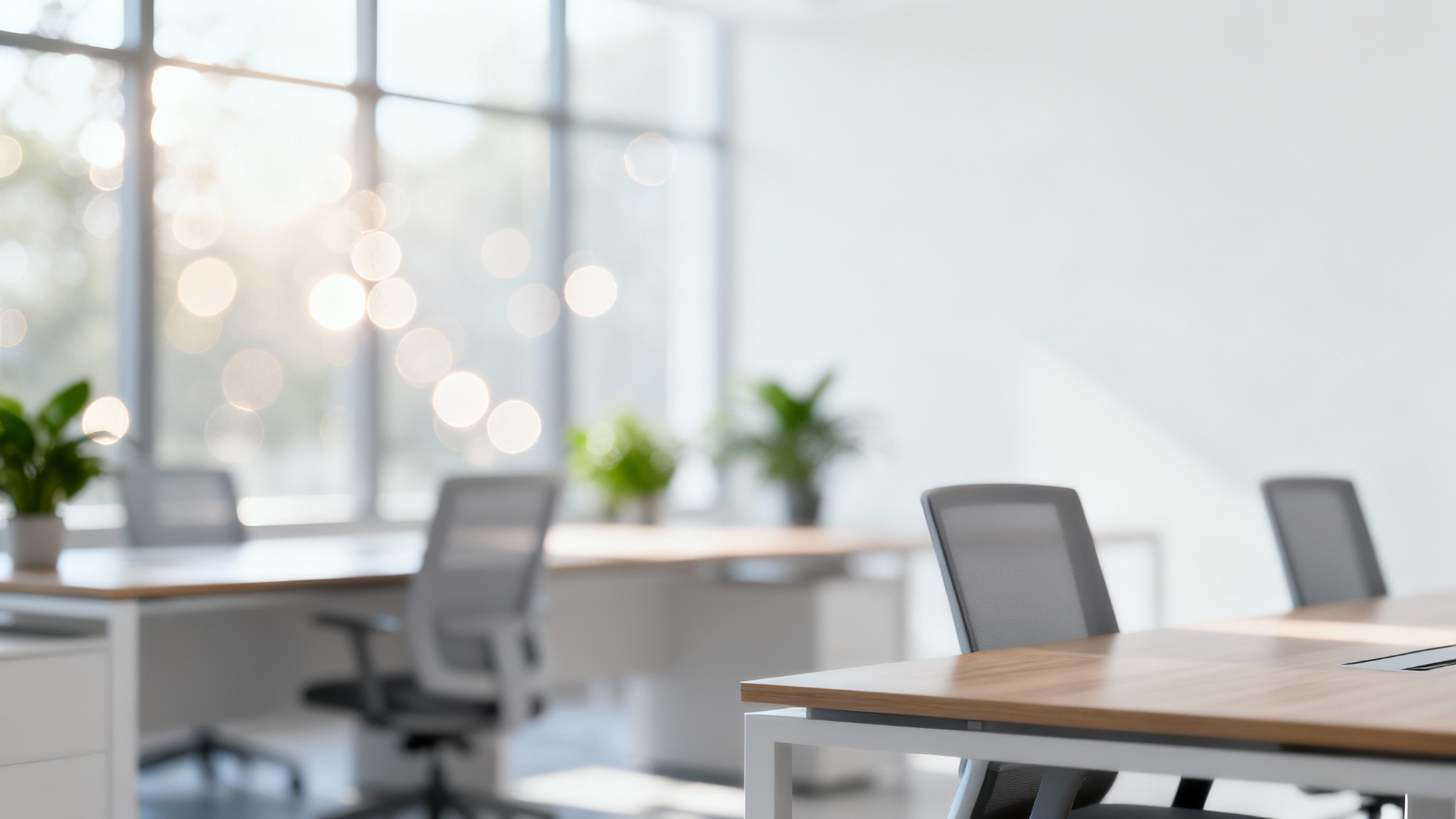 A professionally shot image of a modern office interior, heavily blurred to create a soft, clean, and non-distracting virtual background with bokeh lights.