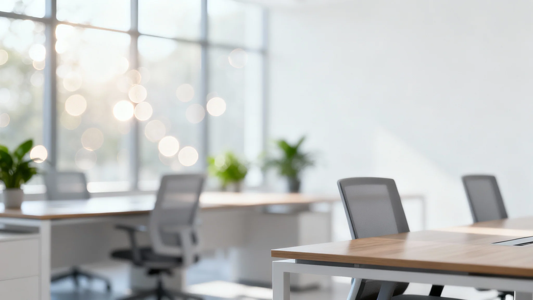 A professionally shot image of a modern office interior, heavily blurred to create a soft, clean, and non-distracting virtual background with bokeh lights.