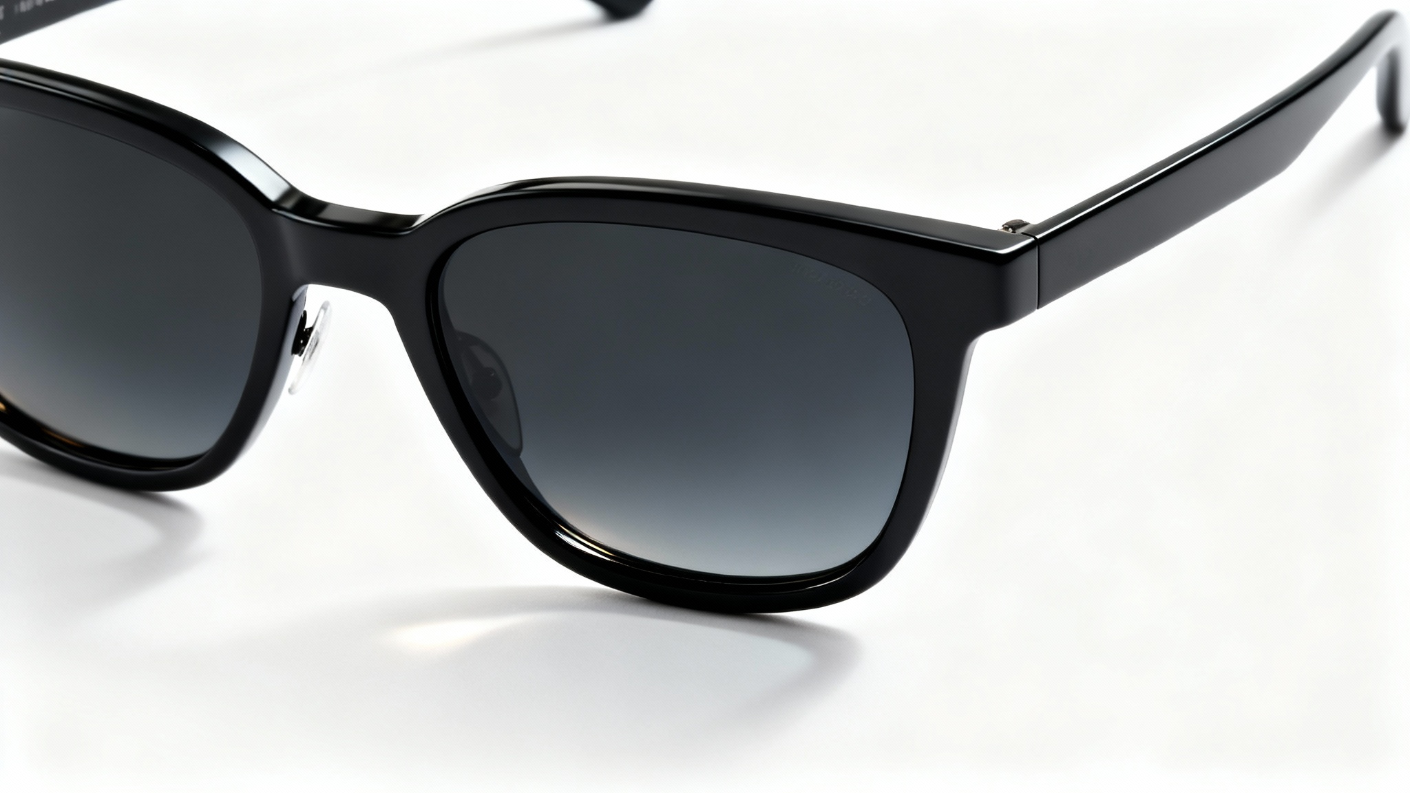 A pair of modern sunglasses with matte black frames and dark polarized lenses, shown in a professional product photo against a plain white background.
