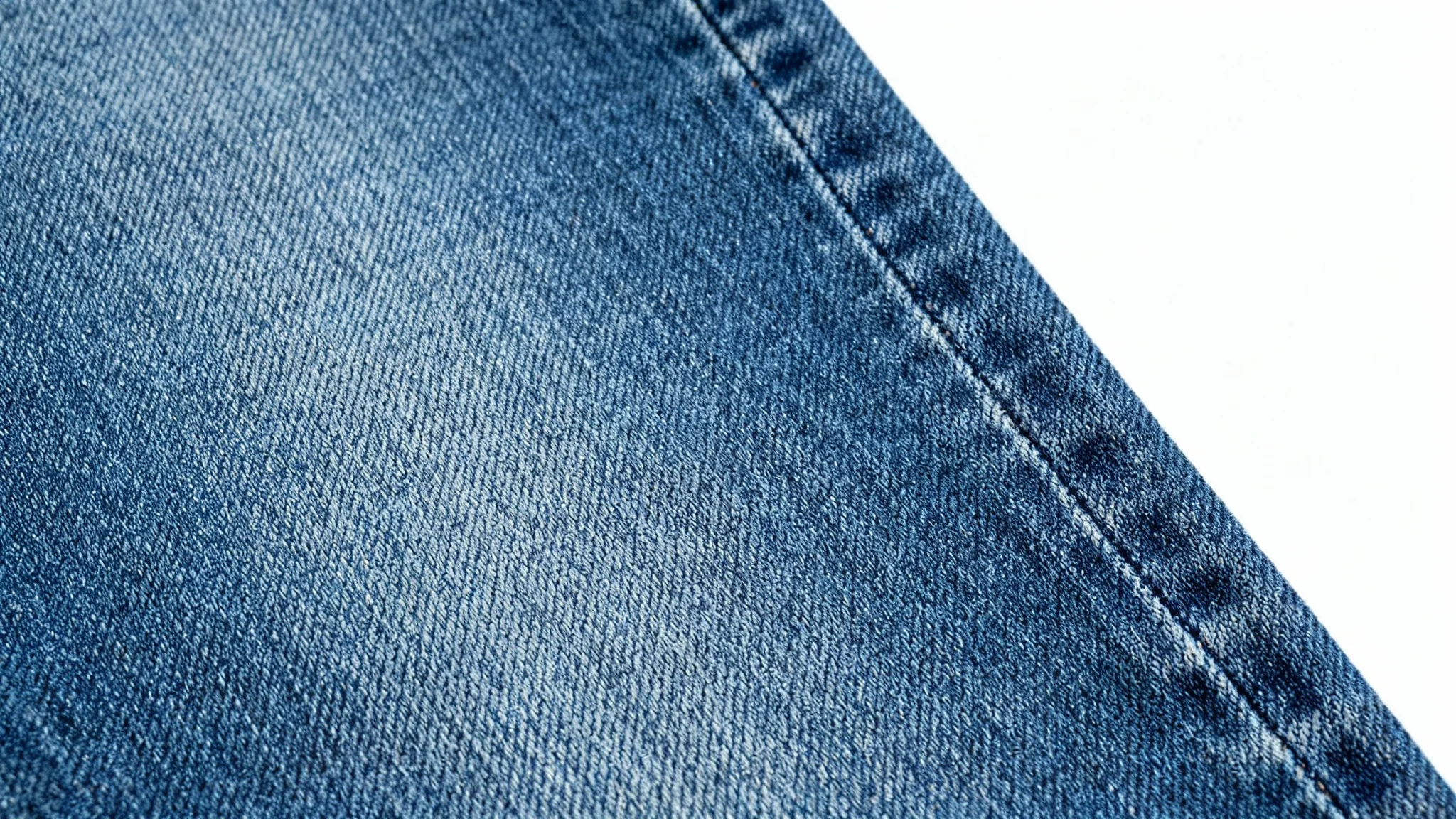 A seamless, high-resolution texture of blue denim fabric shown in a detailed close-up shot against a white background.