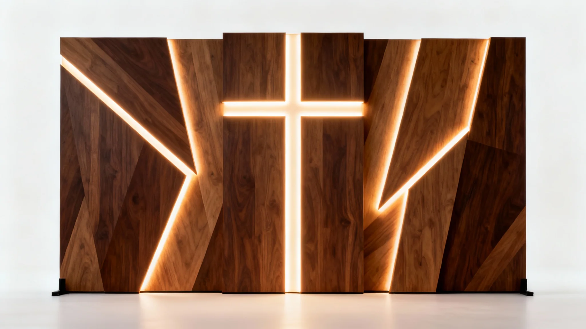 A modern church stage backdrop design featuring intersecting dark wood panels with an abstract cross illuminated by glowing LED lights, shown against a plain white background.