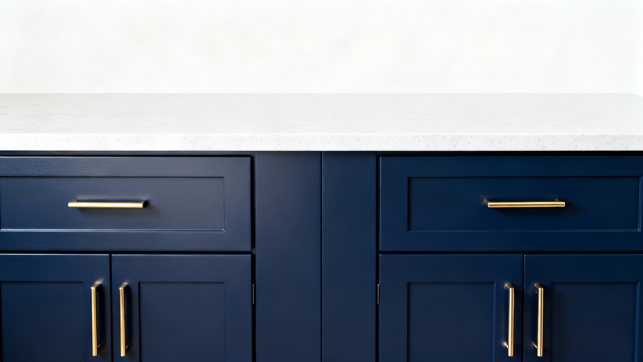 A photorealistic image of modern kitchen cabinets painted in a rich navy blue, with elegant brass handles, set against a plain white background.