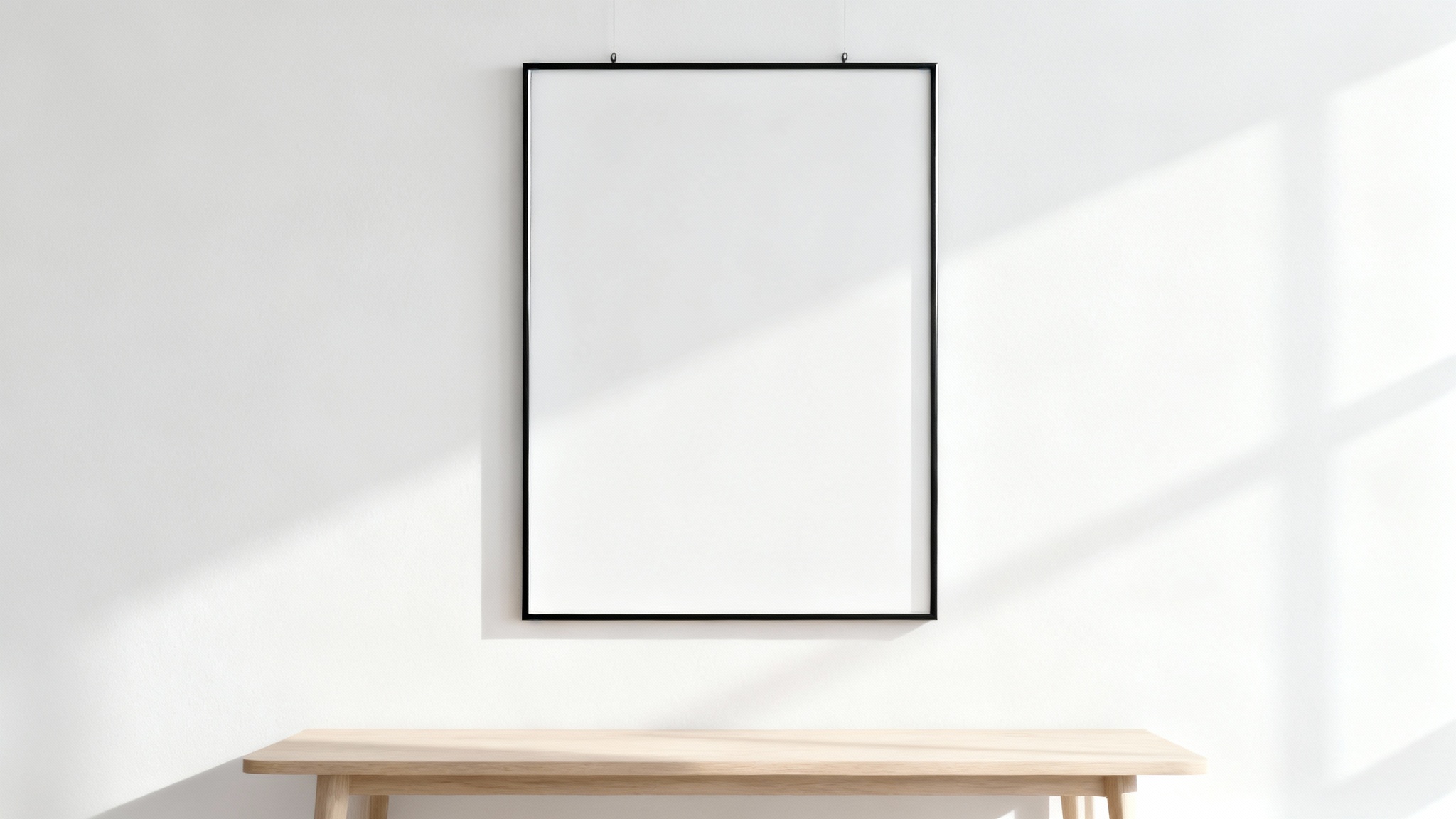 A minimalist mockup of a single black rectangular frame hanging on a white wall, representing a wall frame mockup.