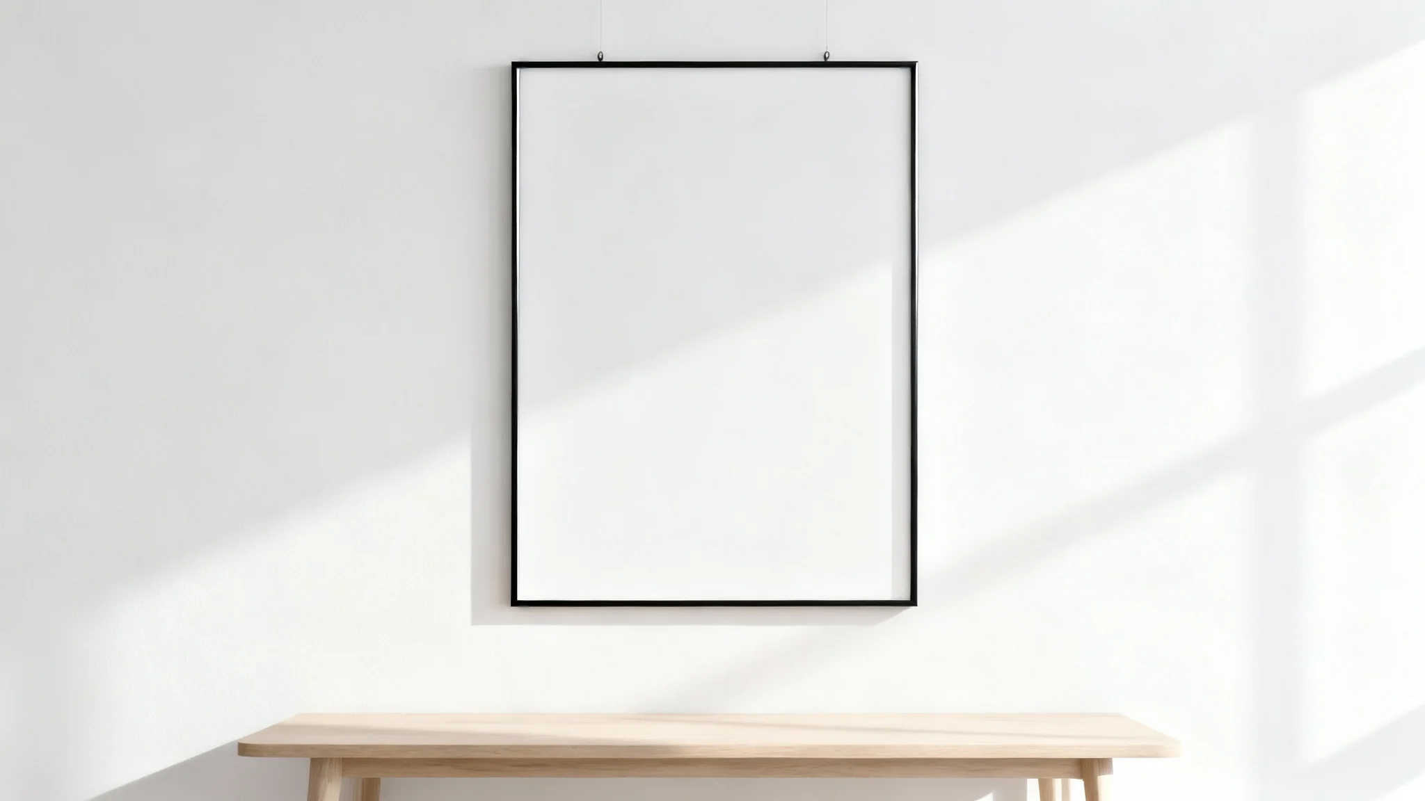 A minimalist mockup of a single black rectangular frame hanging on a white wall, representing a wall frame mockup.